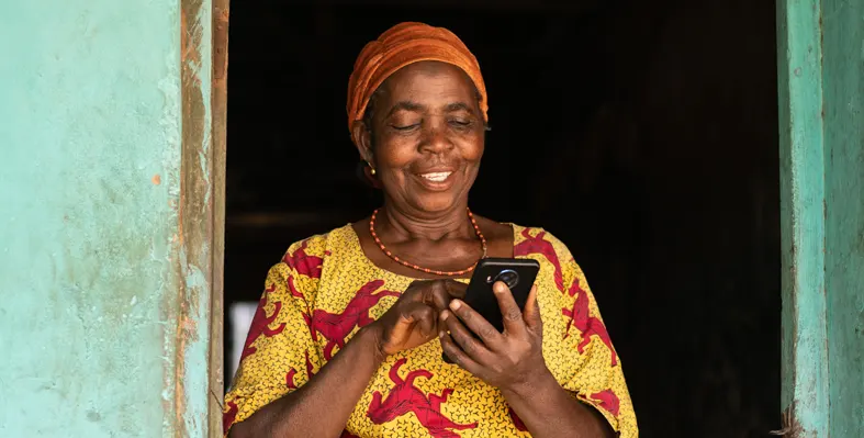 African women smiling while scrolling the phone 