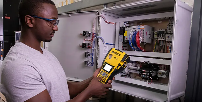 Image of a man working on the Brady printer