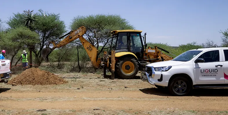 Towering crane excavating earth on active site