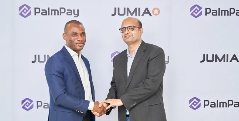 Chika Nwosu and Sunil Natraj exchanging a handshake at a conference.