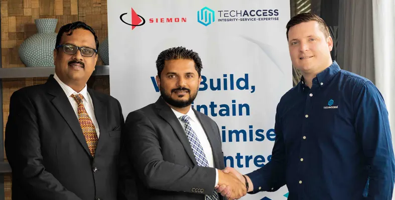 Delegates from Siemon and Tech Access engaging in a handshake to mark their partnership