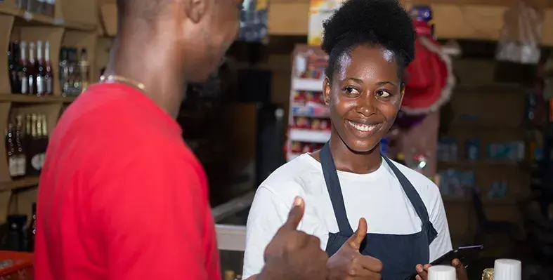 Two_Africa's_young_people_show_thumbs_up_while_mobile_money_transaction