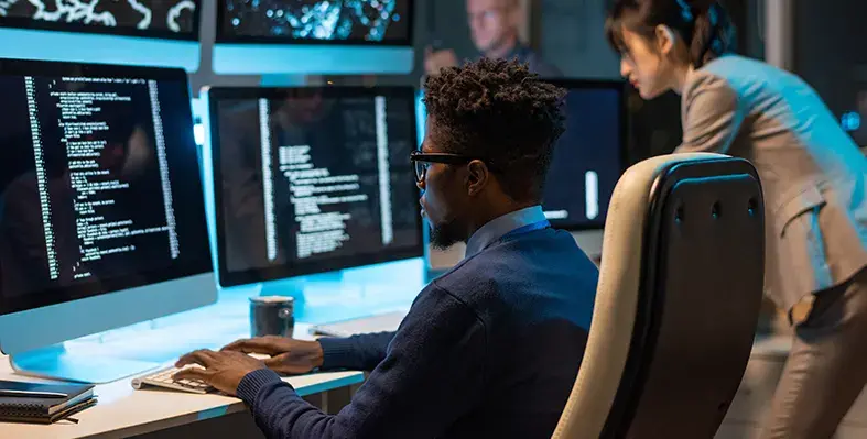 A_man_working_on_huge_computer_screen