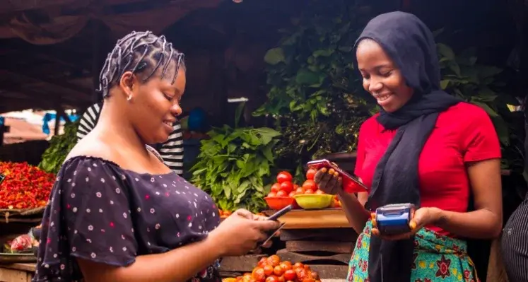 Women_sharing_money_via_phone