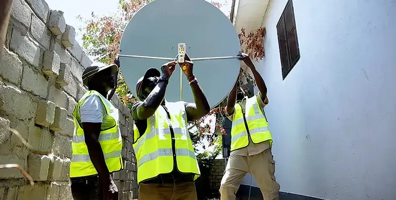 Two_men_setting_up_satellites